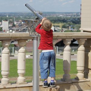 Garçon qui regarde dans une longue vue